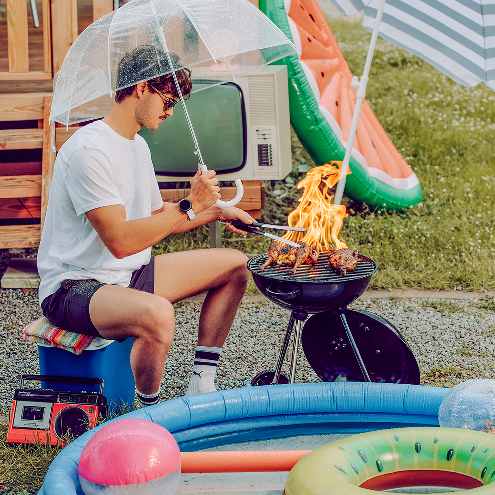 huge flames coming out of the grill and a big bird is lying on the grill